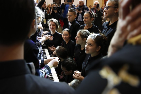 Twenty Bosnian children prepare to play &quot;Galop Marche&quot;, a classical piece by Albert Lavignac, in an attempt to set a Guinness record in largest number of people performing a single compositi ...