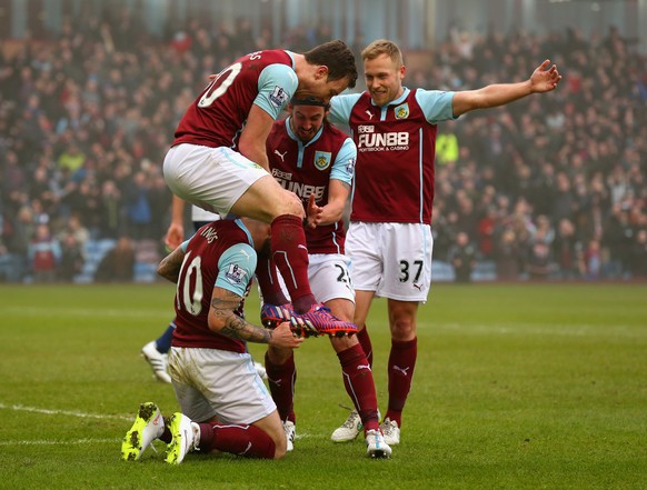 BURNLEY, ENGLAND - FEBRUARY 08: Goalscorer Ashley Barnes of Burnley jumps on Danny Ings of Burnley as he celebrates scoring the opening goal during the Barclays Premier League match between Burnley an ...