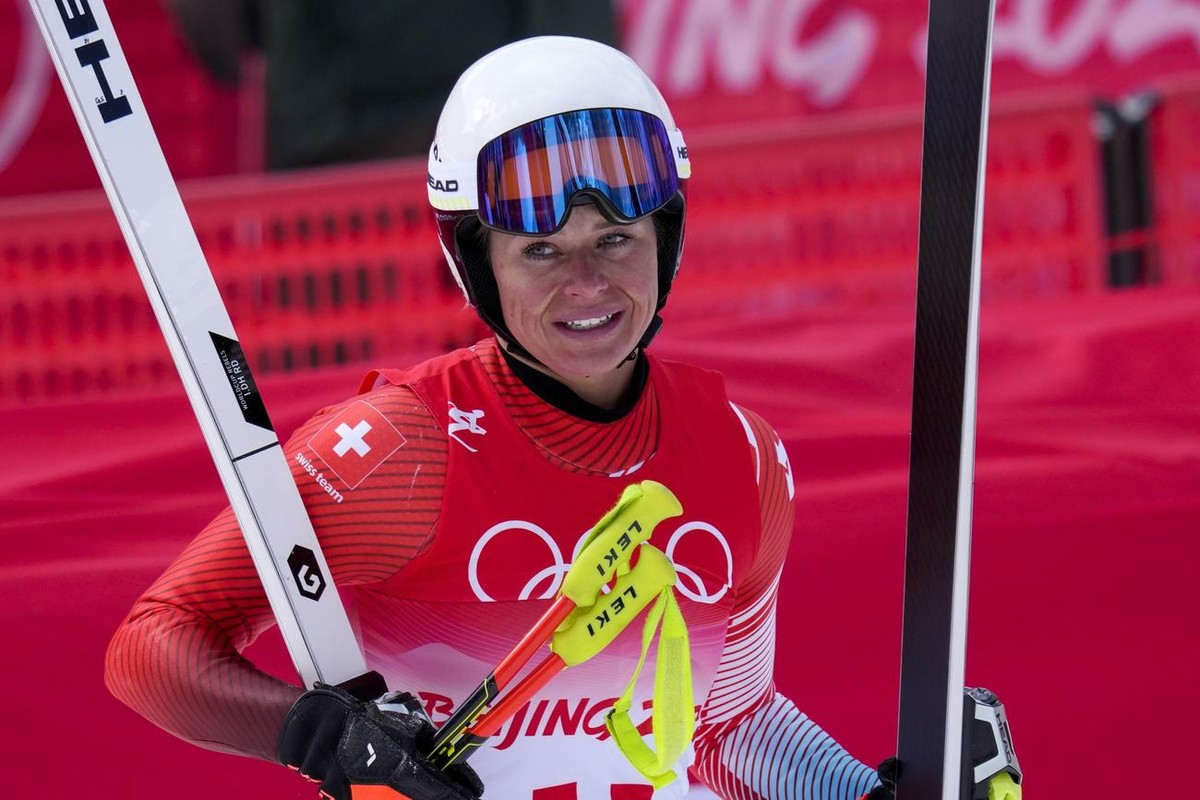 Corinne Suter, of Switzerland, gestures after finishing the women's downhill at the 2022 Winter Olympics, Tuesday, Feb. 15, 2022, in the Yanqing district of Beijing. (AP Photo/Luca Bruno)