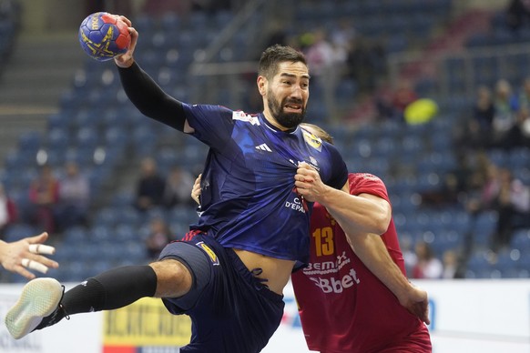 Montenegro&#039;s Mirko Radovic, right, in action against France&#039;s Nikola Karabatic during the Main Round Group I, Handball World Championship match between France and Montenegro in Krakow, Polan ...