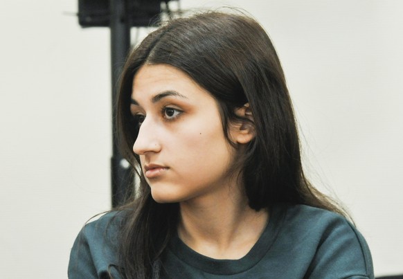 In this photo taken on Wednesday, June 26, 2019, Maria Khachaturyan attends hearings in a court room in Moscow, Russia. Three Khachaturyan sisters, now aged 18, 19 and 20, face charges for the premedi ...