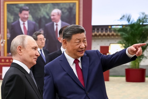 Russian President Vladimir Putin, left, and Chinese President Xi Jinping visit an exhibition by the TASS and Xinhua news agencies at the Great Hall of the People, in Beijing, China, on Wednesday, May  ...