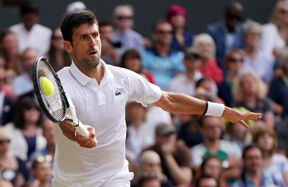 epaselect epa07717093 Novak Djokovic of Serbia returns to Roger Federer of Switzerland in the men&#039;s final of the Wimbledon Championships at the All England Lawn Tennis Club, in London, Britain, 1 ...