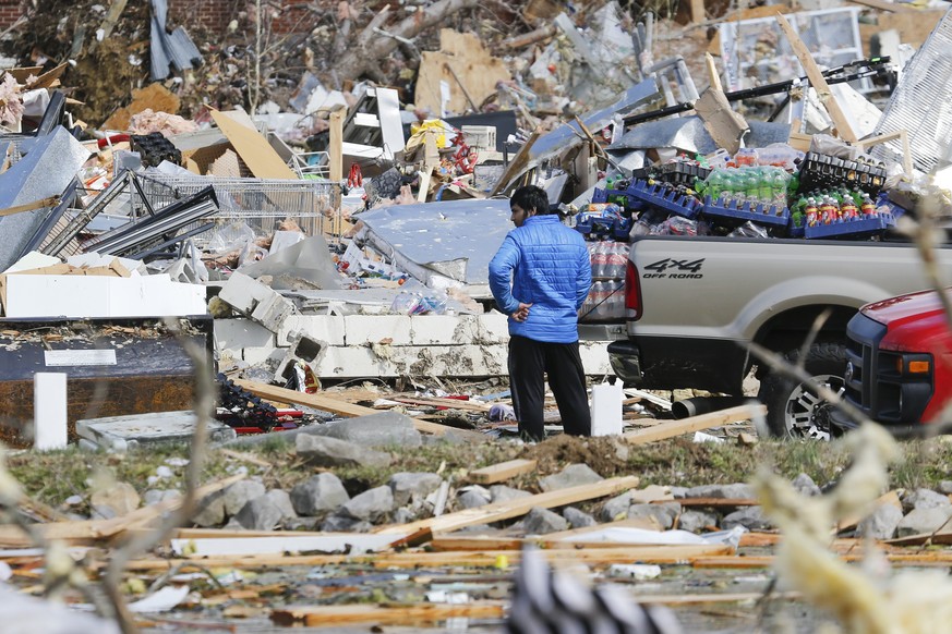 A man looks for items he can salvage from his store Tuesday, March 3, 2020, near Cookeville, Tenn. Tornadoes ripped across Tennessee early Tuesday, shredding more than 140 buildings and burying people ...
