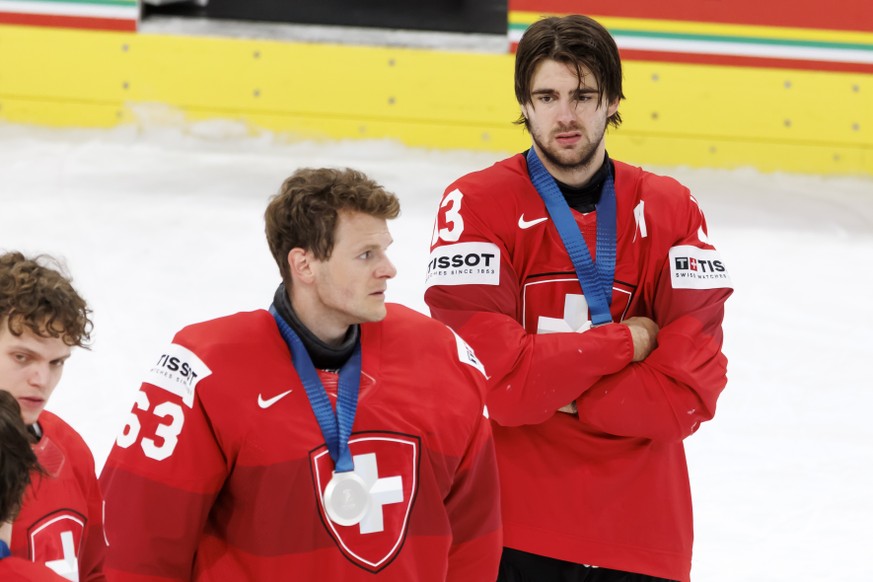 Switzerland's goaltender Leonardo Genoni, left, and Switzerland's Nico Hischier, right, react with disappointment after the defeat of the 2026 IIHF Men's Ice Hockey World Championship g ...