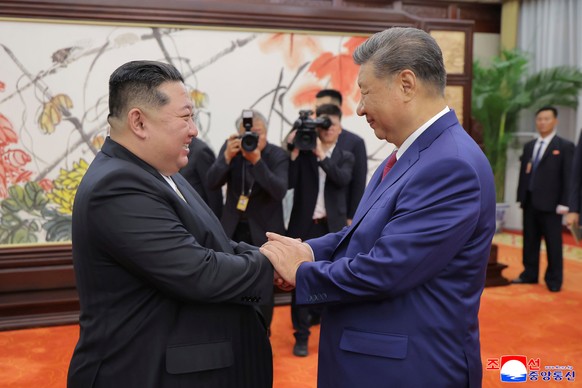 FILE - In this photo provided by the North Korean government, North Korean leader Kim Jong Un, left, shakes hands with Chinese President Xi Jinping in Beijing Thursday, Sept. 4, 2025. Independent jour ...