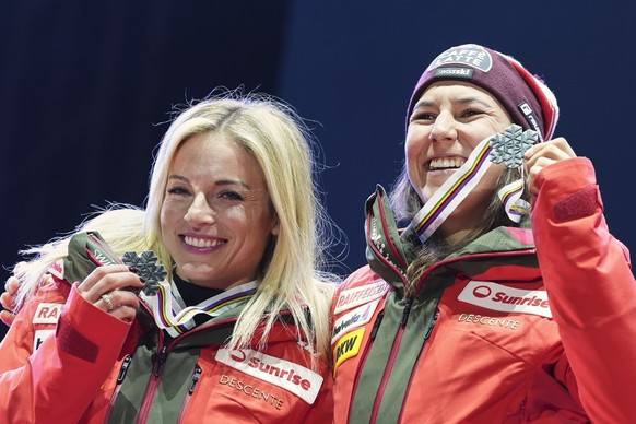Switzerland's Lara Gut Behrami, left, and Switzerland's Wendy Holdener hold their silver medals for a women's team combined event, at the Alpine Ski World Championships, in Saalbach-Hin ...