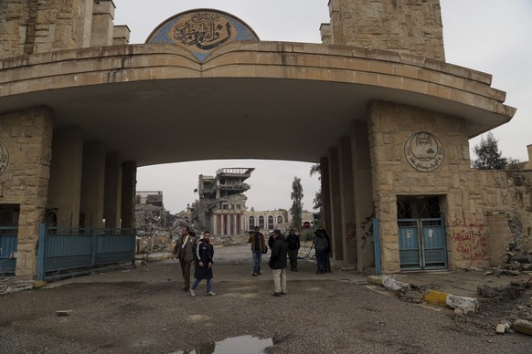 Students inspect their badly damaged university after it was recently liberated from Islamic State militants, on the eastern side of Mosul, Iraq, Sunday, Jan. 22, 2017. (AP Photo/ Khalid Mohammed)