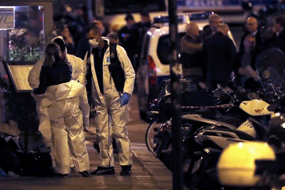 epa06732055 French forensic police officers put on scrubs next to the place where a man attacked and stabbed several people in Paris, France, 12 May 2018. According to the latest reports, two persons  ...