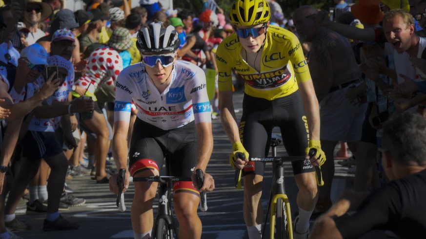 Denmark&#039;s Jonas Vingegaard, wearing the overall leader&#039;s yellow jersey, and Slovenia&#039;s Tadej Pogacar, wearing the best young rider&#039;s white jersey, climb Alpe d&#039;Huez during the ...