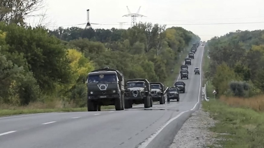 epa10173788 A handout still image taken from handout video provided by the Russian Defence ministry press-service shows military vehicles of the Russian army moving in the Kharkov region, Ukraine, 09  ...