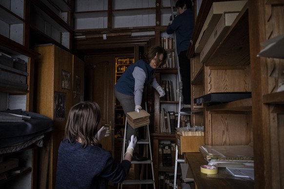 Workers at the rare manuscripts and old printed books department of the Andrey Sheptytsky National Museum store them in cardboard boxes to reduce the risk of damage in the event of an attack in the we ...