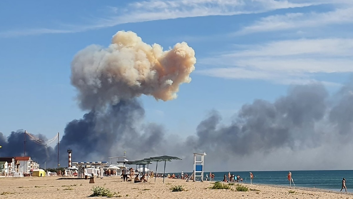 FILE - Rising smoke can be seen from the beach at Saky after explosions were heard from the direction of a Russian military airbase near Novofedorivka, Crimea, Aug. 9, 2022. The Crimean Peninsula' ...