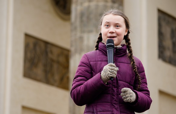epa07470736 Swedish climate activist Greta Thunberg (C) speaks in front of Brandenburg Gate during a &#039;Fridays for Future&#039; demonstration against climate change in Berlin, Germany, 29 March 20 ...