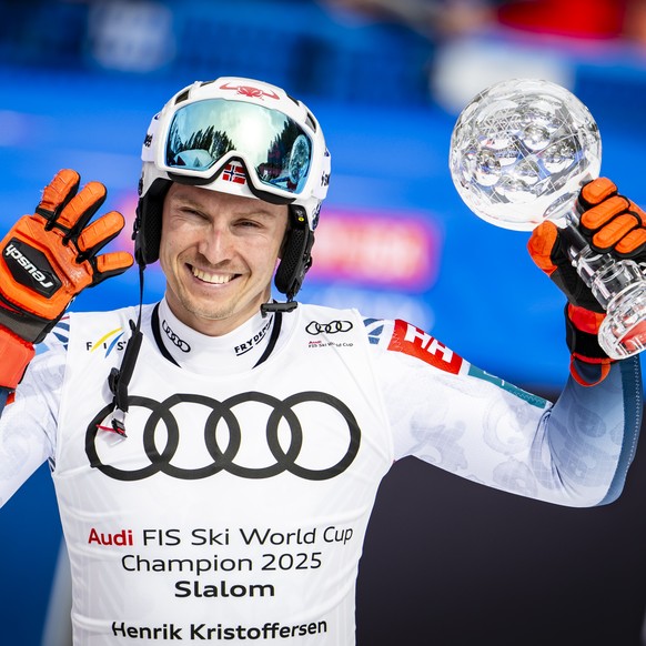 Henrik Kristoffersen of Norway celebrates with the men&#039;s Slalom discipline leader crystal globe trophy during the second run of the men&#039;s Slalom race at the FIS Alpine Ski World Cup Finals,  ...