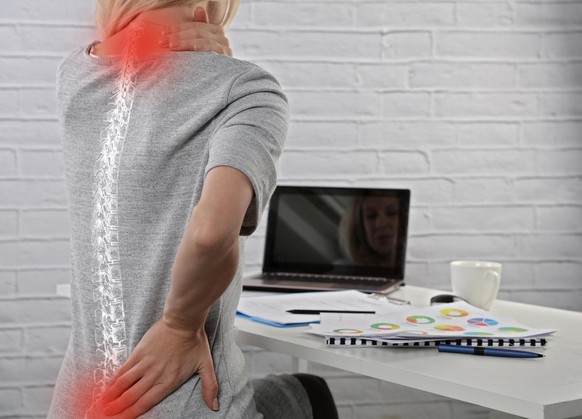 Business Woman suffering from back pain. Incorrect sitting posture problems. Pain relief, chiropractic concept.