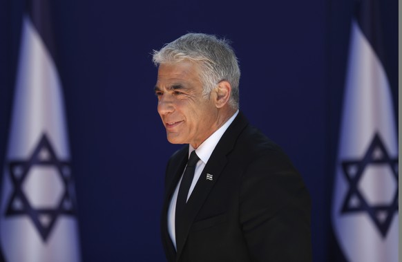 epa09269614 Alternate Prime Minister and Minister of Foreign Affairs Yair Lapid arrives at the Israeli President residence, for a joint photo with the new government ministers at the President&#039;s  ...