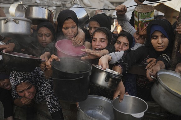 Palestinians struggle to get donated food at a community kitchen in Gaza City, northern Gaza Strip, Monday, July 14, 2025. (AP Photo/Jehad Alshrafi)
Israel Palestinians
