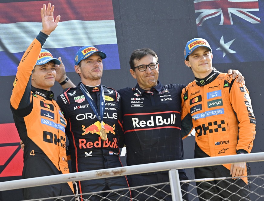 epa12359728 (L-R) Second placed McLaren driver Lando Norris of Britain, winner Red Bull Racing driver Max Verstappen of the Netherlands, Red Bull Racing Technical Chief Pierre Wache, and third placed  ...