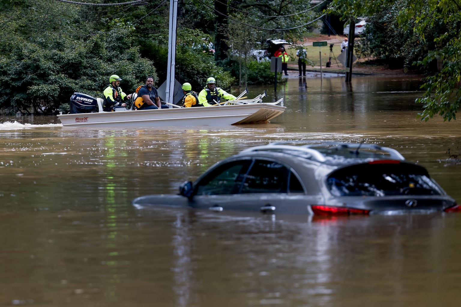 epa11629173 Members of the Atlanta Fire Rescue ..Department&#039;s Swift Water Rescue Team bring Darryl Hall (C) to dry land after his Buckhead neighborhood home was swamped by the flood waters of Pea ...