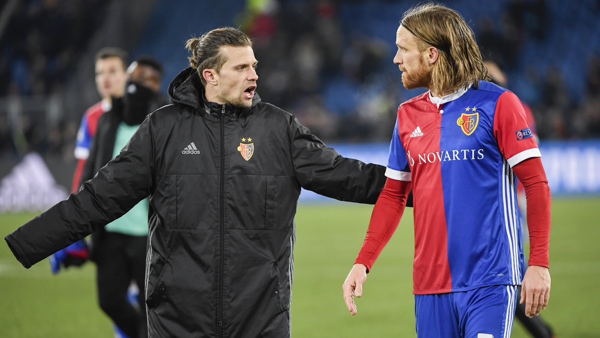 Basel's Valentin Stocker, left, and Michael Lang show dejection after the UEFA Champions League round of sixteen first leg soccer match between Switzerland's FC Basel 1893 and England's ...