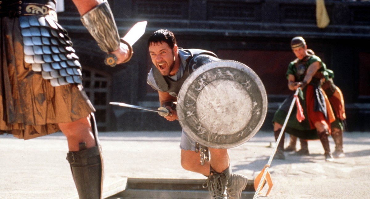 Russell Crowe center fights a gladiator in his role as Roman general Maximus, in this handout photo from Universal's film "Gladiator," directed by Ridley Scott. Colleagues say the 36-ye ...