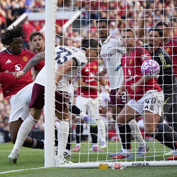 Arsenal&#039;s Riccardo Calafiori scores his sides first goal during the English Premier League soccer match between Manchester United and Arsenal at Old Trafford stadium in Manchester, England, Sunda ...