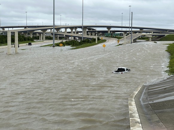 A vehicle is stranded in high waters on a flooded highway in Houston, on Monday, July 8, 2024, after Beryl came ashore in Texas as a hurricane and dumped heavy rains along the coast. (AP Photo/Juan A. ...
