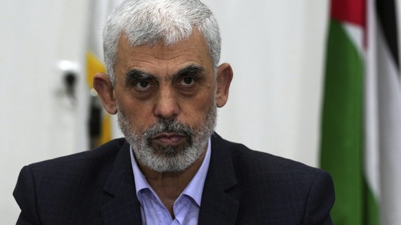 FILE - Yahya Sinwar, head of Hamas in Gaza, chairs a meeting with leaders of Palestinian factions at his office in Gaza City, Wednesday, April 13, 2022. The Hamas officials are accused by the ICC of p ...