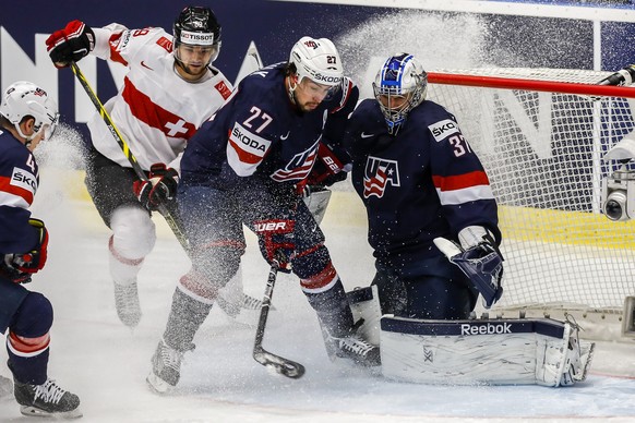 OSTRAVA, CZECH REPUBLIC - MAY 14:  Justin Faulk (C) of USA stops the puck in front of  goalkeeper Connor Hellebuyck (R) of USA and Cody Almondo (L) of Switzerland during the IIHF World Championship quaterfinal match between USA and Switzerland at CEZ Arena on May 14, 2015 in Ostrava, Czech Republic.  (Photo by Matej Divizna/Getty Images)