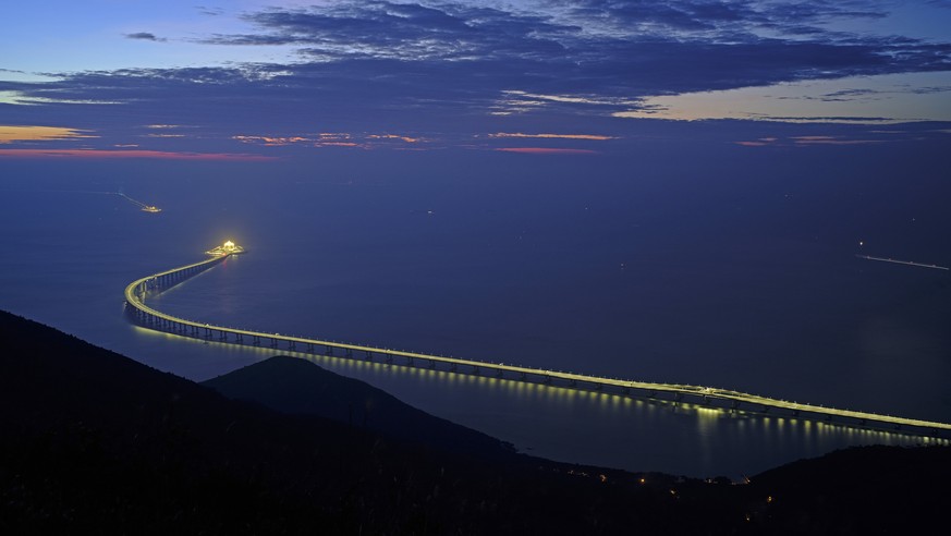 In this Sunday, Oct. 21, 2018, photo, the Hong Kong-Zhuhai-Macau Bridge is lit up in Hong Kong. The bridge, the world&#039;s longest cross-sea project, which has a total length of 55 kilometers (34 mi ...