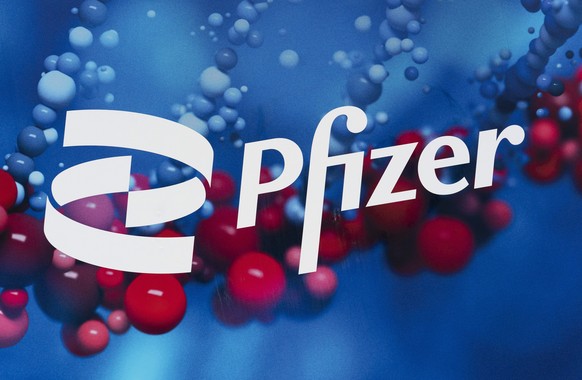 FILE - This Feb. 5, 2021, file photo shows the Pfizer logo displayed at the company&#039;s headquarters in New York. Pfizer says its experimental pill for COVID-19 cut rates of hospitalization and dea ...