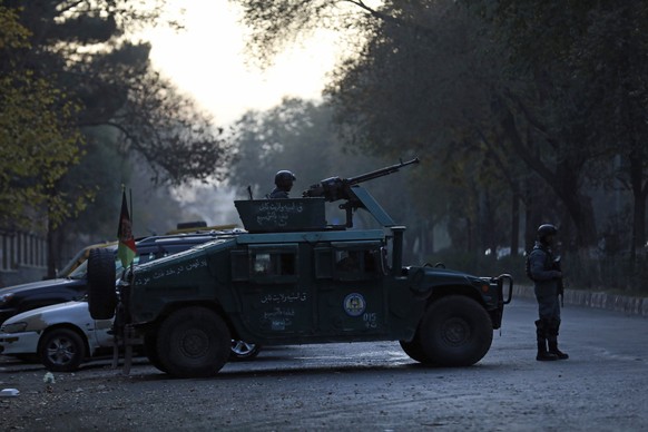 Afghan police patrol at the site of an attack at Kabul University in Kabul, Afghanistan, Monday, Nov. 2, 2020. The brazen attack by gunmen who stormed the Kabul University has left many dead and wound ...