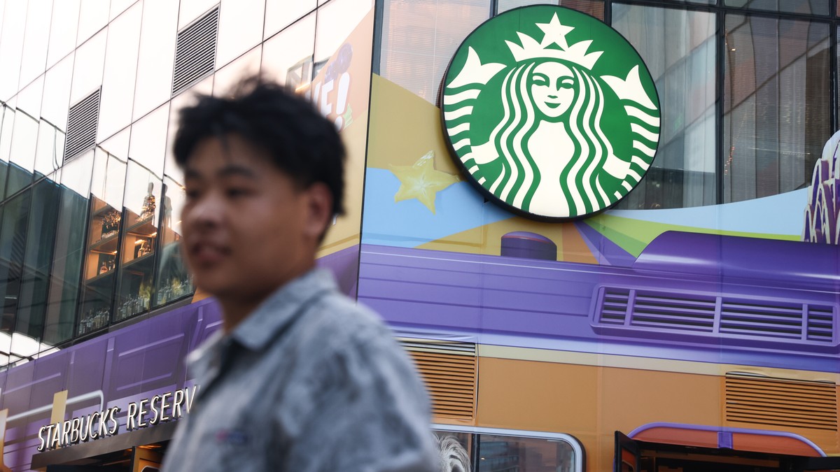 epa12268360 A man walks past a Starbucks in Beijing, China, 28 July 2025. US and Chinese economic officials will resume new talks in Stockholm on 28 July, aiming to agree a 90-day extension to their t ...