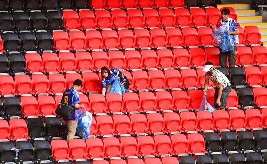epa10331979 Fans of Japan clean up the stands after the FIFA World Cup 2022 group E soccer match between Japan and Costa Rica at Ahmad bin Ali Stadium in Doha, Qatar, 27 November 2022. EPA/Neil Hall