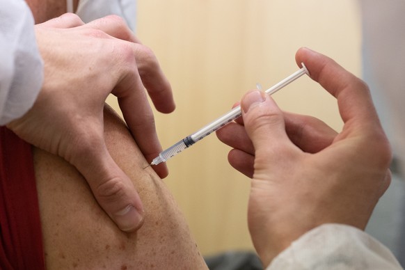 epa09723124 A man receives a shot of Covid-19 vaccine in Bordeaux, France, 02 February 2022. The facility provides adults, and children between 5 and 11 year of age, with either Pfizer or Moderna vacc ...