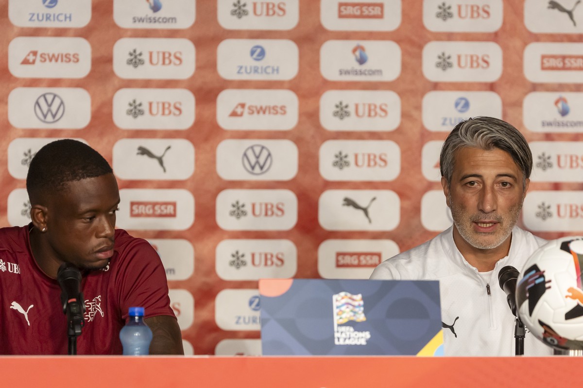 Switzerland's Head coach Murat Yakin, right, sitting next to Switzerland's midfielder Denis Zakaria, left, talks to the media during a press conference of the national team of Switzerland on ...