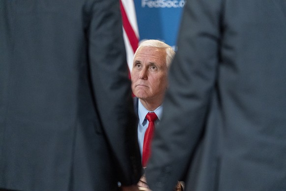 Former Vice President Mike Pence visits a supporter as he signs a copy of his book "so help me God" after speaking at the Federalist Society Executive Branch Review conference, Tuesday,…