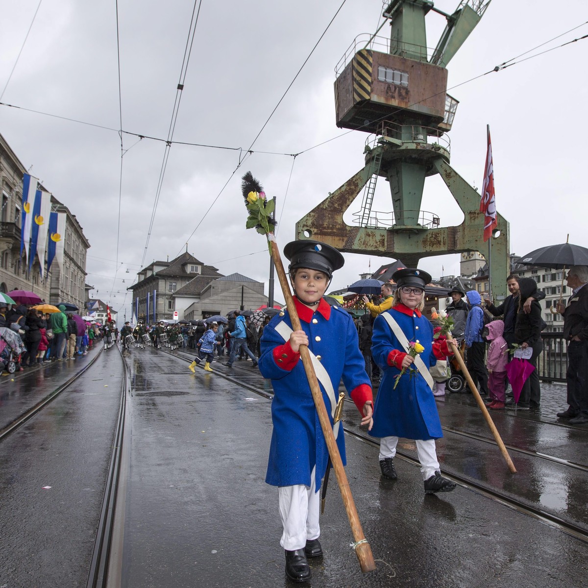 epa04182741 Children wearing colorful costumes march in the children's parade as part of the 'Sechselaeuten' celebrations, in Zurich, Switzerland, 27 April 2014. Sechselaeuten is a trad ...