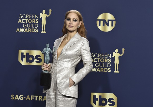 Jessica Chastain, winner of the award for outstanding performance by a female actor in a leading role for &quot;The Eyes of Tammy Faye,&quot; poses in the press room at the 28th annual Screen Actors G ...