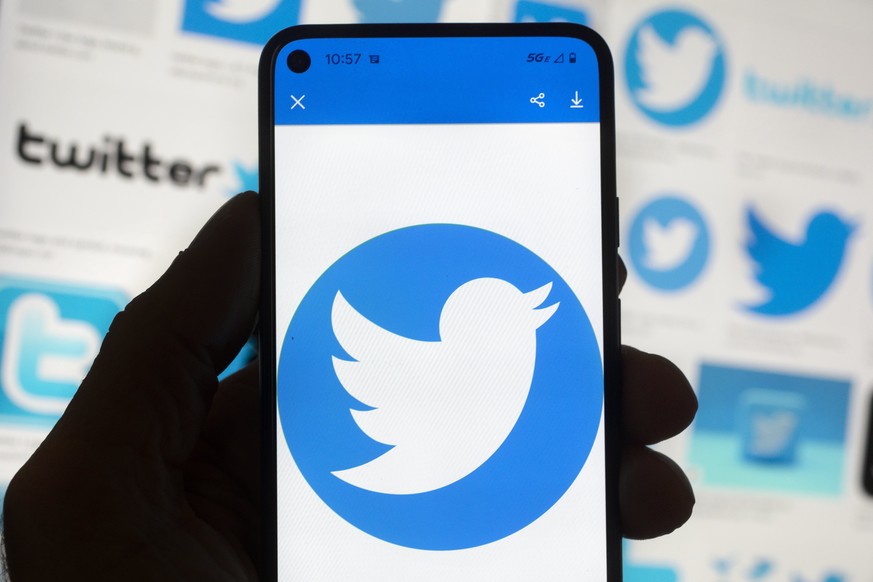 The Twitter logo is seen on a cell phone, Friday, Oct. 14, 2022, in Boston. While amount of chaos is expected after a corporate takeover, as are layoffs and firings, Elon Musk