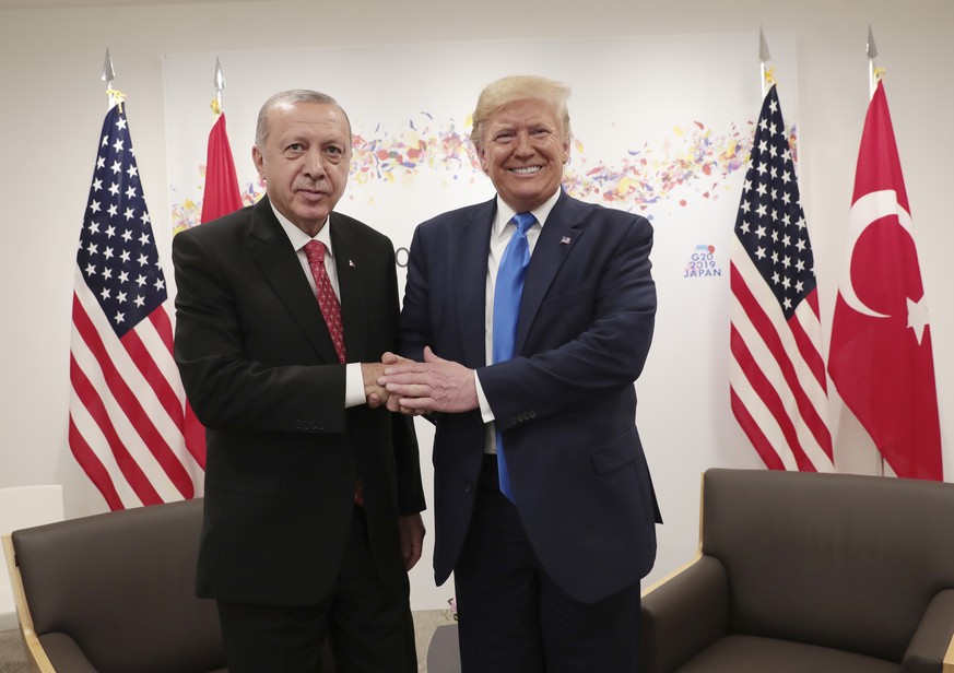 Turkey's President Recep Tayyip Erdogan, left, and U.S. President Donald Trump, right, shake hands during a meeting on the sidelines of the G-20 summit in Osaka, Japan, Saturday, June 29, 2019. (Presi ...