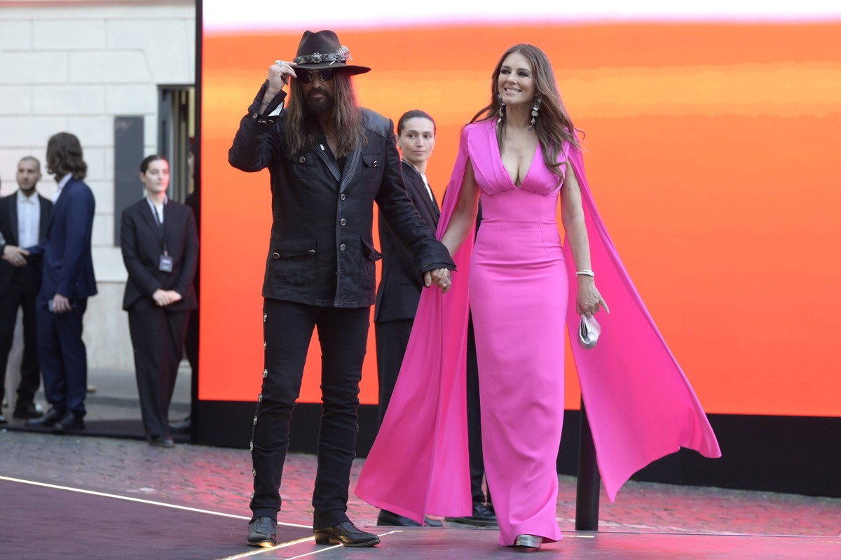 May 24, 2025, Rome, Italy: Billy Ray Cyrus l and Elizabeth Hurley r leave the Red Horizons exhibition by Valentino Foundation at Piazza Mignanelli. Rome Italy - ZUMAs197 20250524_aaa_s197_272 Copyrigh ...
