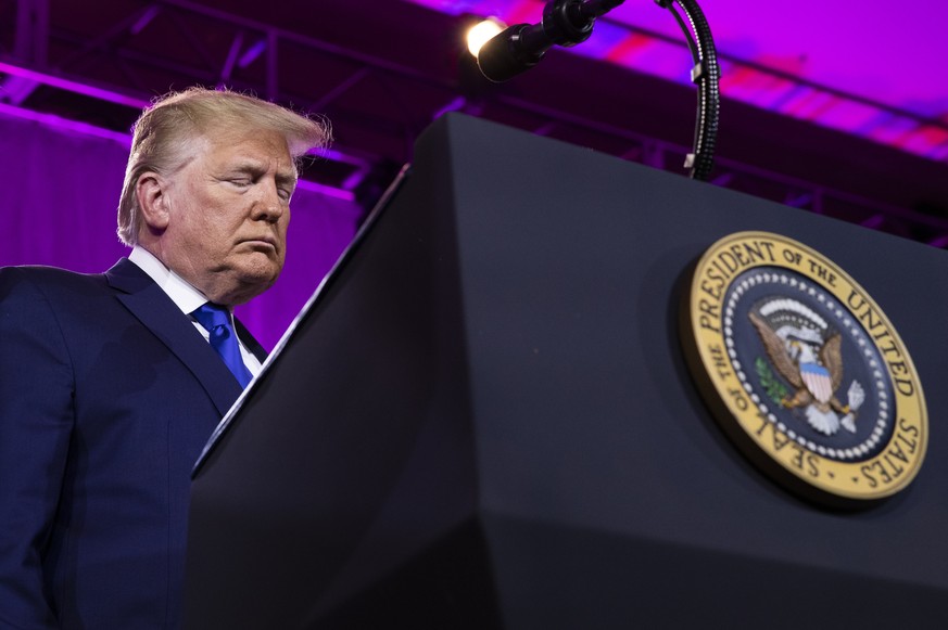 FILE - In this Saturday, Oct. 12, 2019, file photo, President Donald Trump bows his head down as they say their prayer at the Values Voter Summit in Washington. Three liberal groups are launching new  ...