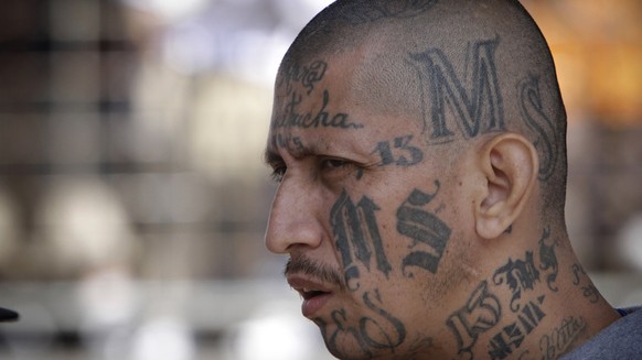 FILE - In this March 26, 2012 file photo a gang member of MS-13 attends mass at a prison in Ciudad Barrios, El Salvador. MS-13, or the Mara Salvatrucha, is believed by federal prosecutors to have thou ...