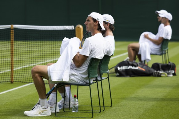 Switzerland&#039;s Marc-Andrea Huesler, front, takes a break during a training session at the All England Lawn Tennis Championships in Wimbledon, London, Saturday, June 25, 2022. The Wimbledon Tennis  ...