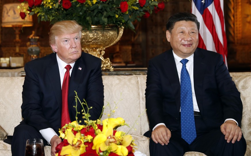 FILE - In this April 6, 2017, file photo, President Donald Trump and Chinese President Xi Jinping sit as they pose for photographers before a meeting at Mar-a-Lago in Palm Beach, Fla. Following his me ...