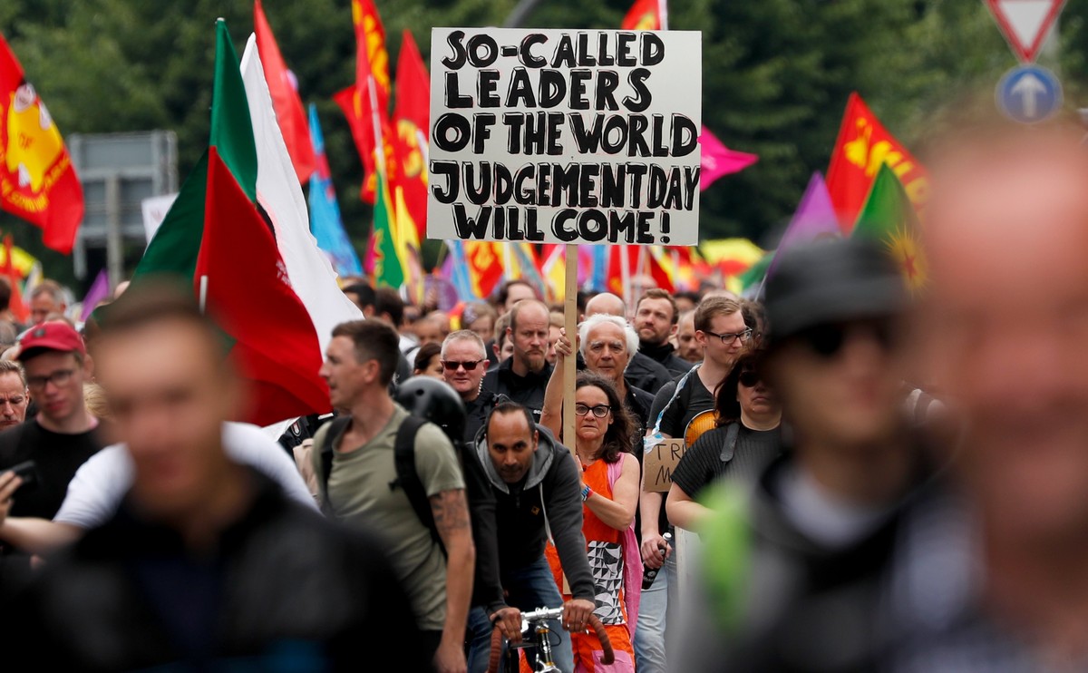 epa06075908 Protesters show a placard reading 'So-called leaders of the world, Judgement Day will come' on the 'Hamburg shows attitude' demonstration during the G-20 summit in Hamb ...