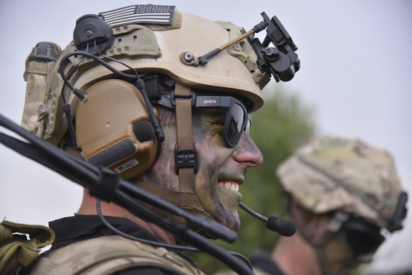 epa07001025 A US instructor smiles during the Rapid Trident drills on a shooting range, near Lviv, Ukraine, 06 September 2018. The practical phase of the Rapid Trident-2018 international military dril ...