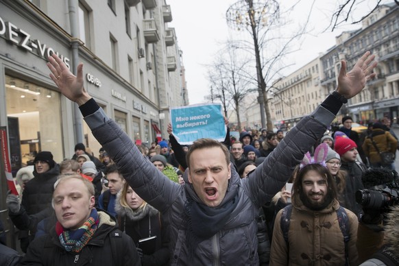 FILE - In this Sunday, Jan. 28, 2018 file photo, Russian opposition leader Alexei Navalny, centre, attends a rally in Moscow, Russia. Navalny, who is President Vladimir Putin&#039;s most visible and v ...